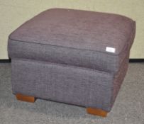 An upholstered foot stool, in purple chenille,
