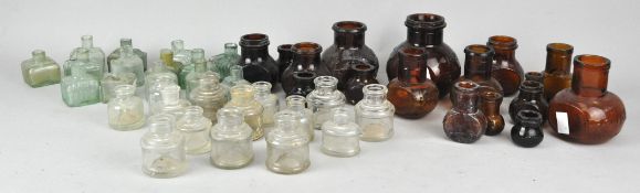A collection of Bovril and period ink bottles in brown glass and clear. Tallest measures; 11cm.