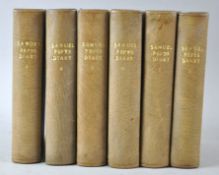 A group of leather bound volumes,