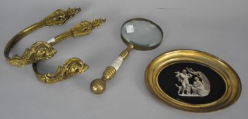 A magnifying glass, tin tray and pair of gilt curtain tie backs. Magnifying glass measures 26cm.