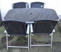 A metal and glass garden table with umbrella stretcher, 66cm high x 150cm wide x 90cm deep,