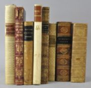 A group of leather bound volumes,