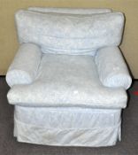 An upholstered armchair. Measures; 76cm x 84cm x 84cm.