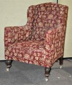 A red upholstered armchair on casters,