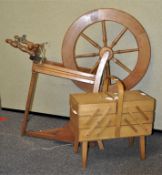 A 20th Century spinning wheel along with metamorphic sewing box on angled legs.