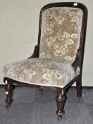 A Victorian mahogany upholstered nursing chair. Measures; 96cm.