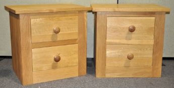 A pair of Jumbos of Henlow oak two drawer bedside cabinets on plain bases,