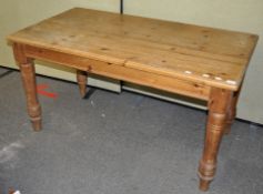 A 20th Century country pine refectory table raised on turned legs. Measures; 74cm x 137cm x 76cm.