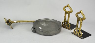 A pair of brass book ends,a pewter warming dish and a brass rack. Bookends measure; 19cm high.