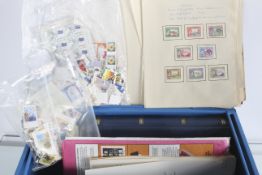 A collection of assorted stamp albums and packets within a metal safe box with key.