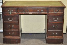 A mahogany pedestal desk, inlaid with green leather top,