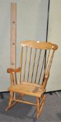 A pine rocking chair, 108cm high and a pine coat rack,