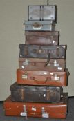 A collection of seven assorted suitcase mostly leather along with a record case.