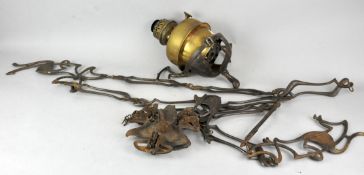 A late 19th to early 20th Century cast metal hanging brass oil lamp with fittings.