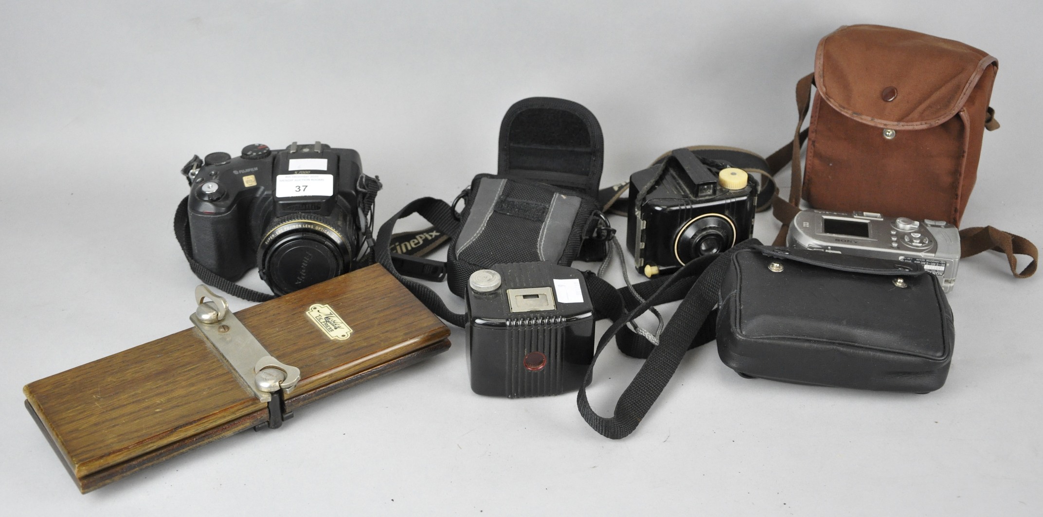 A collection of assorted cameras to include fujifilm and Kodak.