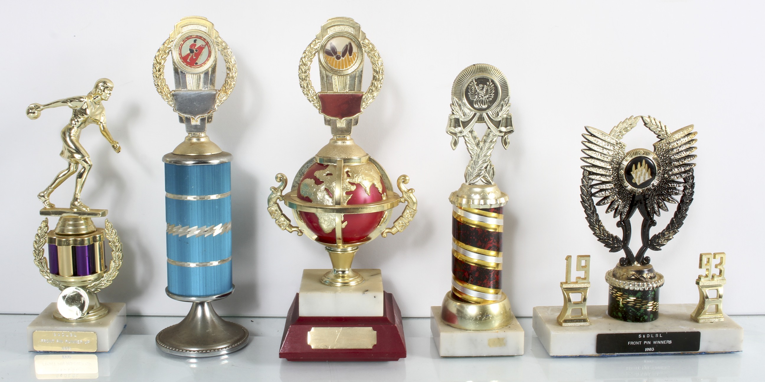 A collection of assorted skittle trophies