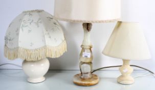 A collection of four table lamps to include two onyx examples and two pottery examples,
