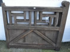 A pair of oak drive gates with fret design tops,