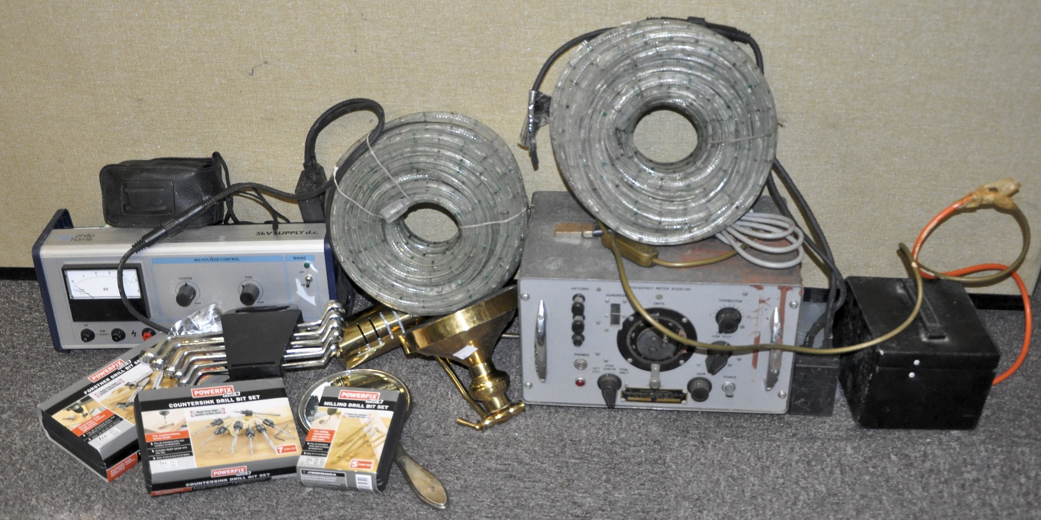 A collection of assorted items to include; frequency meter, tool sets, Christmas lights,