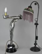 An Art Deco style figural lamp and an Art Nouveau style lamp with glass shade.