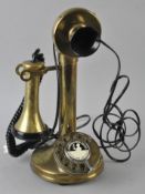 A brass vintage style candlestick telephone.