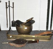 A collection of brass and other fireplace items to include; fire fender, companion set, bellows,