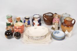 A collection of assorted Staffordshire character jugs with creamware style dish,