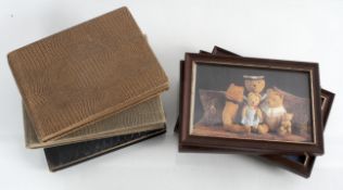 A collection of wooden picture frames along with two period photograph albums