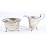 A silver helmet form cream jug, with cut card edge and scroll handle,