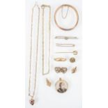 A collection of jewellery to include: Three 9ct gold brooches, A 9ct heart pendant with chain,