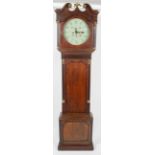 An early 19th century oak and mahogany long case clock case on a plain cut corner base with applied