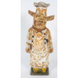 A vintage cast iron doorstop, early 20th century, cast as a pig dressed as a chef,