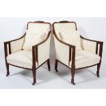 A pair of Edwardian mahogany and line inlaid bergere chairs, with upholstered back,