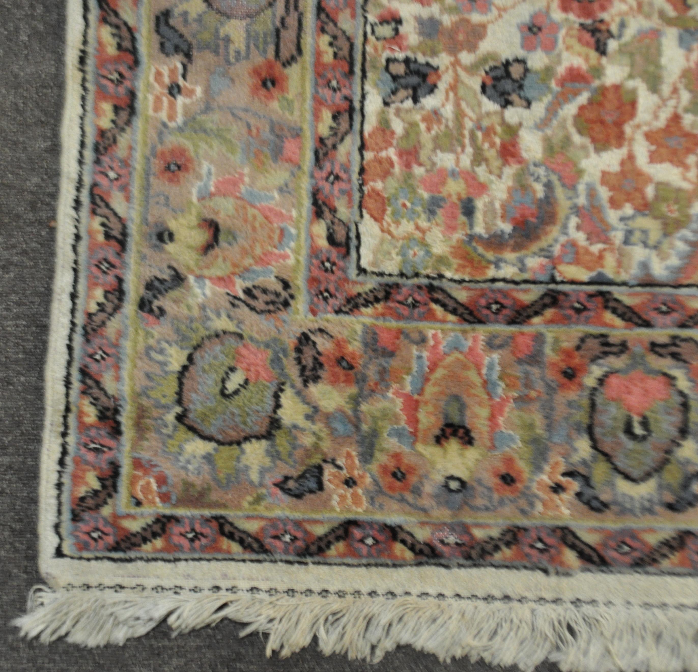 A Middle Eastern carpet the central cream ground with central medallion and floral decoration - Image 3 of 3