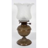 A Victorian brass and glass oil lamp, late 19th century, formed as a gadrooned vase,