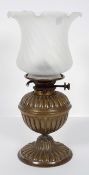 A Victorian brass and glass oil lamp, late 19th century, formed as a gadrooned vase,