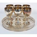 A Sheffield plated circular tray and six plated wine goblets, the tray stamped Alpha Plate,