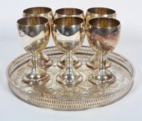 A Sheffield plated circular tray and six plated wine goblets, the tray stamped Alpha Plate,