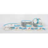 An English porcelain tea set late 19th century, painted with flowers beneath a blue and gilt rim,