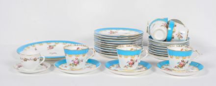 An English porcelain tea set late 19th century, painted with flowers beneath a blue and gilt rim,
