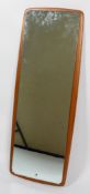 A 1960's- 70's dressing mirror, of rectangular form, mounted on cushion shaped teak mount,