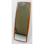 A 1960's- 70's dressing mirror, of rectangular form, mounted on cushion shaped teak mount,