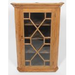 A George III stripped pine corner cupboard,