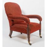 A late 19th century armchair with curved padded back with over stuffed sloping arms over a plain