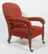 A late 19th century armchair with curved padded back with over stuffed sloping arms over a plain