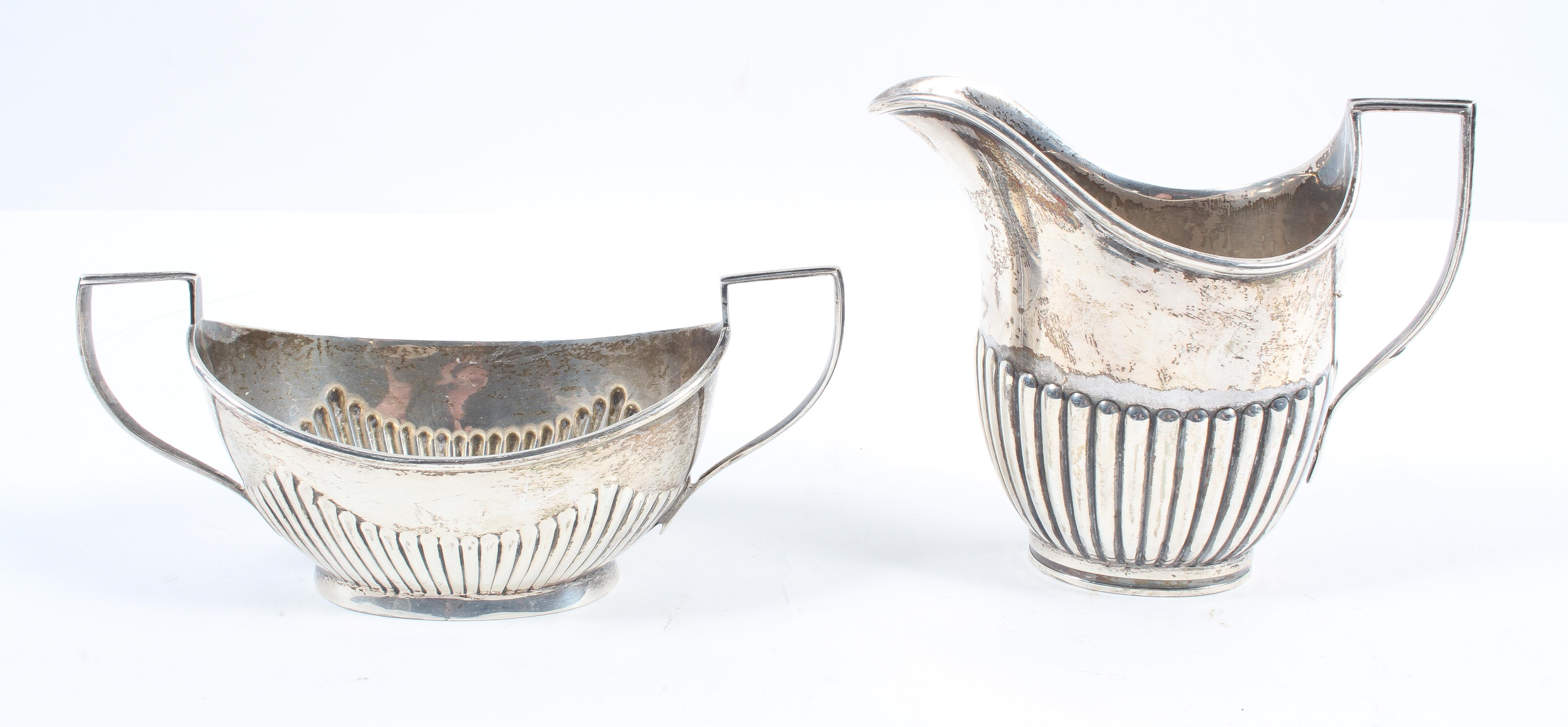 A silver milk jug, of traditional oval form with a half ribbed body, London 1903, 10cm high,