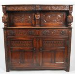 A Victorian carved oak credenza, late 19th century, carvd in a 17th century style,