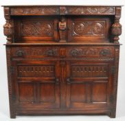 A Victorian carved oak credenza, late 19th century, carvd in a 17th century style,