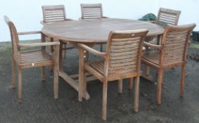 A large teak garden table, 76cm high x 180cm wide x 120cm deep, together with six chairs, 76cm high,