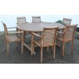 A large teak garden table, 76cm high x 180cm wide x 120cm deep, together with six chairs, 76cm high,